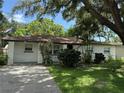 Charming one-story home featuring a well-maintained lawn and mature landscaping at 4661 Linwood St, Sarasota, FL 34232