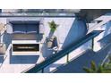 Stylish balcony with an outdoor seating area, fireplace, and sleek water feature at 688 Golden Gate Point # 202, Sarasota, FL 34236