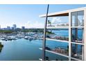 Luxurious waterfront condo building with balconies overlooking a picturesque marina at 688 Golden Gate Point # 202, Sarasota, FL 34236