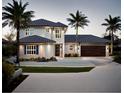 This stunning two-story home features modern design and beautiful palm trees in the landscape at 7809 20Th W Pl, Bradenton, FL 34209