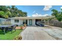 Charming home featuring stone walkway, small yard, covered parking area, and a light turquoise front door at 809 40Th St, Sarasota, FL 34234