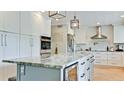 Modern kitchen with a large island, stainless steel appliances, and custom cabinets at 9403 9Th Nw Ave, Bradenton, FL 34209