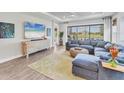 Comfortable living room with a large sectional couch, big windows and a modern TV at 3025 Veneto Ct, Bradenton, FL 34211