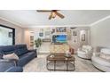 Cozy living room featuring comfortable seating, a stylish coffee table, and unique wall decor at 11200 Whimbrel Ln, Sarasota, FL 34238