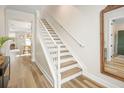 Bright stairway with light wood floors and white railings, seamlessly connecting the home's levels at 12017 Cranston Way, Bradenton, FL 34211