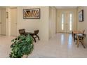 Bright foyer with decorative tile, double front doors, bench, and plenty of closet space at 154 Inlets Blvd, Nokomis, FL 34275