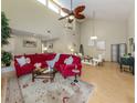Open-concept living room with bamboo flooring, high ceilings, fan, and lots of natural light at 154 Inlets Blvd, Nokomis, FL 34275