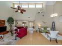Spacious living room with vaulted ceilings, fan, bamboo flooring, and open floor plan at 154 Inlets Blvd, Nokomis, FL 34275