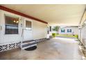 Open carport providing ample space for parking with direct access to the home's entrance at 170 Edgewood Dr, Osprey, FL 34229