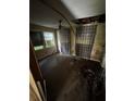 Shows an empty bedroom with dirty, aged floor and walls and a hole in the ceiling at 2026 Seminole S Blvd, St Petersburg, FL 33705