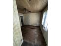 Shows an empty living room with dirty, aged floor and walls and a dated ceiling fan at 2026 Seminole S Blvd, St Petersburg, FL 33705