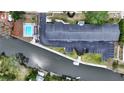 Aerial view of the condo complex, showing the community pool, boat docks, waterway, and parking areas at 2124 Tamiami N Trl # 103, Sarasota, FL 34234
