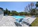 Community pool area with lounge chairs and a well-maintained patio at 2124 Tamiami N Trl # 103, Sarasota, FL 34234