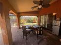 Covered patio with ceiling fan and outdoor seating next to the yard at 303 70Th Nw St, Bradenton, FL 34209