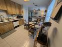 Kitchen featuring wood cabinets and tile floor that opens to the living room at 3237 Pine Haven Dr, Clearwater, FL 33761