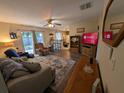Comfortable living room with wood-look floors offering seamless flow into the kitchen and access to backyard at 3237 Pine Haven Dr, Clearwater, FL 33761