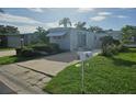 Charming residence with awning, mailbox, landscaping, and spacious driveway at 3324 Laurel Oak Way, Sarasota, FL 34237