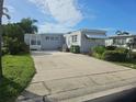 Cozy gray home with a spacious concrete driveway and minimal landscaping at 3324 Laurel Oak Way, Sarasota, FL 34237