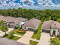 Aerial shot of homes with lush green landscaping under a partly cloudy blue sky at 3602 Secret Stroll Dr, Sarasota, FL 34240
