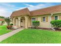 Inviting home exterior featuring a quaint covered entry and well-maintained lawn at 3905 34Th Avenue W Dr # 36, Bradenton, FL 34205