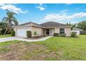 Well-maintained single-story home with a two-car garage and lush green lawn at 4649 72Nd E Ct, Bradenton, FL 34203