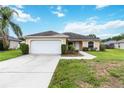 Inviting single-story home featuring a well-maintained lawn, a two-car garage, and a sidewalk leading to the front door at 4649 72Nd E Ct, Bradenton, FL 34203