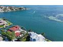 Aerial view of waterfront home, highlighting the pool, lush landscaping and the dock on the water at 585 Gunwale Ln, Longboat Key, FL 34228