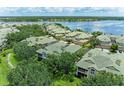 A stunning aerial view of a lakeside community with lush greenery and well-maintained homes at 6536 Moorings Point Cir # 101, Lakewood Ranch, FL 34202