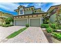 A charming two-story home with a two-car garage and a brick driveway at 6536 Moorings Point Cir # 101, Lakewood Ranch, FL 34202