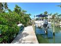 Private boat dock with a boat lift offering convenient access to waterways at 701 Marbury Lane, Longboat Key, FL 34228