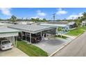 Charming single-story mobile home with covered parking and a well-maintained lawn at 719 50Th Avenue W Ter, Bradenton, FL 34207