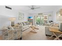 Bright living room featuring comfortable seating and sliding glass doors to a balcony at 915 Beach Rd # 321, Sarasota, FL 34242