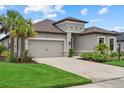 View of well maintained one-story home and 2 car garage with well manicured front lawn and landscaping at 9291 Starry Night Ave, Sarasota, FL 34241