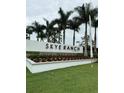 Sign for Skye Ranch Sarasota neighborhood lined by palm trees at 9291 Starry Night Ave, Sarasota, FL 34241