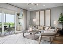 Stylishly designed living room featuring modern decor, comfortable seating, and a sliding door to a patio at 9994 Key Haven Rd, Seminole, FL 33777