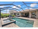 Home boasts a private pool with spa, lounging area, outdoor dining and a view of neighboring homes at 11550 Blackfin St, Venice, FL 34292