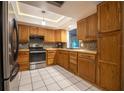 Well-appointed kitchen featuring wooden cabinetry, stainless steel appliances, and a classic tile backsplash at 1208 Francis Ave, Sarasota, FL 34232