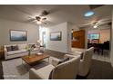 Bright living room featuring neutral furniture, ceiling fan, and seamless flow to the adjacent dining area and kitchen at 1208 Francis Ave, Sarasota, FL 34232