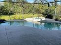 Inviting screened-in pool and hot tub area surrounded by lush greenery, perfect for relaxation at 12342 Lavender Loop, Bradenton, FL 34212