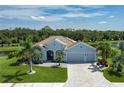 Desirable home on an oversized lot, with a paver driveway and three-car garage, surrounded by mature palms and greenery at 15808 42Nd E Gln, Parrish, FL 34219