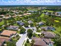 Aerial view of single Gathering home in quiet neighborhood with lake at 280 Dahlia Ct, Bradenton, FL 34212