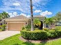 Charming front exterior featuring well-manicured landscaping and a two-car garage at 280 Dahlia Ct, Bradenton, FL 34212