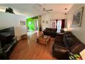 Spacious living room with hardwood floors, comfortable sofas, and a sliding glass door at 3918 Wake Ave, Sarasota, FL 34241