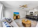 Bright living room featuring tile floors, comfortable sofa, and a flat-screen TV for relaxing entertainment at 441 62Nd St, Holmes Beach, FL 34217