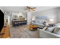Open-concept living room with modern decor, comfortable seating, and a view into the kitchen and breakfast bar at 441 62Nd St, Holmes Beach, FL 34217