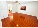 Spacious living room featuring sleek, cherry-wood laminate flooring and ample natural light at 5238 Sunridge Palms Dr, Tampa, FL 33617