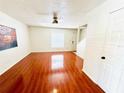 Bright living room showcases beautiful laminate flooring, ceiling fan, and a view of the staircase at 5238 Sunridge Palms Dr, Tampa, FL 33617