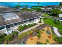 Aerial view of a home surrounded by manicured landscaping with tropical plants, shrubbery, and stone at 719 Estuary Dr # 719, Bradenton, FL 34209