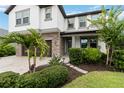 Charming home featuring stone details, a two-car garage, and meticulously manicured landscaping at 731 116Th Ne Ct, Bradenton, FL 34212