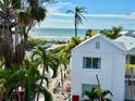 Beautiful beach view from the property surrounded with palms and vegetation with ocean in the background at 7324 Gulf Dr # 12, Holmes Beach, FL 34217